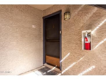 The front door is painted dark blue, and the unit number is visible above the door at 4444 E Paradise Village N Pkwy # 132, Phoenix, AZ 85032