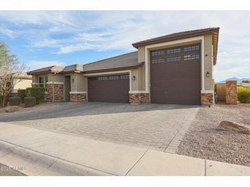 Beautiful single-Gathering home with a three-car garage and a paved driveway at 7735 W Agora Ln, Phoenix, AZ 85043