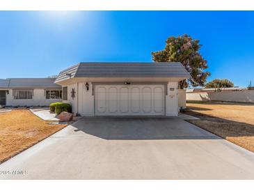 Two car garage with large driveway and well maintained lawn at 10419 W Loma Blanca Dr, Sun City, AZ 85351