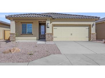 Charming single-story home with desert landscaping and a two-car garage at 11472 W Arron Dr, Youngtown, AZ 85363