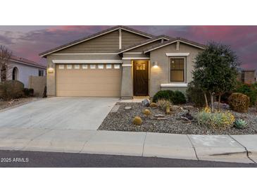 Charming single-story home featuring desert landscaping, a two-car garage, and covered porch entry at 11674 E Yeager Cyn, Gold Canyon, AZ 85118