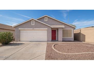 Charming single-story home showcasing a two-car garage and a neatly landscaped front yard at 12888 N B St, El Mirage, AZ 85335