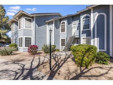 Two-story condo with classic architectural details, complemented by desert landscaping and shade trees at 2910 W Marconi Ave # 105, Phoenix, AZ 85053