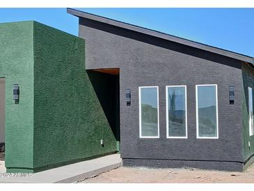 Modern home featuring a unique exterior design, three windows, and contrasting colors at 4215 N Roble Cir, Eloy, AZ 85131