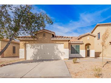 Charming single-story home with a two-car garage and well-maintained front yard at 44792 W Paitilla Ln, Maricopa, AZ 85139