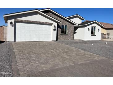 Beautiful exterior with a brick and stucco facade and a paved driveway at 5320 E Pony Track Ln, San Tan Valley, AZ 85140