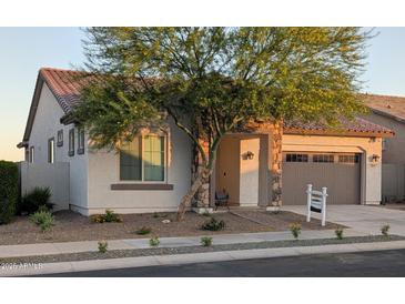 Charming single-story home with desert landscaping, a stone-accented entry, and a tile roof at 20407 W Calle Encorvada --, Buckeye, AZ 85396