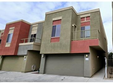 Contemporary townhome featuring a private garage and colorful exterior accents at 3113 E Danbury Rd # 5, Phoenix, AZ 85032