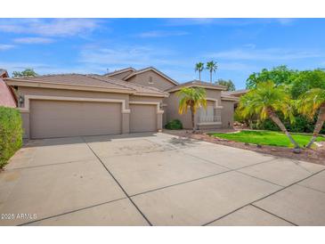 Inviting home featuring a tile roof, 3 car garage, and well maintained desert landscaping at 1079 S Western Skies Dr, Gilbert, AZ 85296