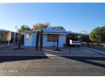 Charming single-story home with a covered parking and desert landscaping at 3160 E Main St # 72, Mesa, AZ 85213