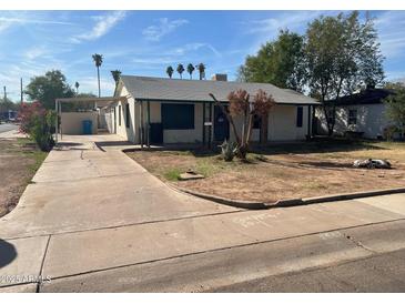 Charming single-story home featuring a cozy porch, driveway, and low maintenance landscaping at 3547 E Polk St, Phoenix, AZ 85008