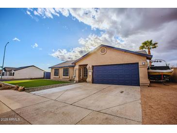 Charming single-story home features a blue garage door, manicured lawn, and ample driveway parking at 502 N 110Th St, Mesa, AZ 85207