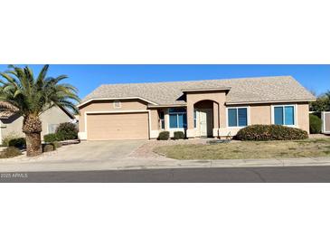 Charming home featuring desert landscaping, a spacious driveway, and a two-car garage at 9318 E El Paso St, Mesa, AZ 85207