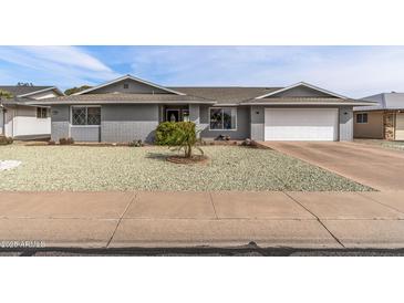 Charming single-story home with xeriscaped front yard and attached two-car garage at 19805 N 99Th Dr, Sun City, AZ 85373