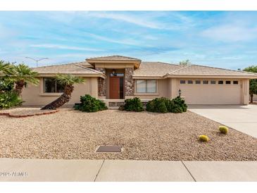 Charming single-story home with a desert-landscaped yard, stone accents, and a two-car garage at 2503 S Tambor --, Mesa, AZ 85209