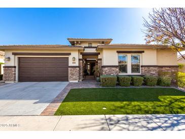 Beautiful single-story home featuring stone accents, a two-car garage, and manicured lawn in a desirable neighborhood at 3749 E Riopelle Ave, Gilbert, AZ 85298