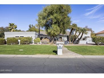 Charming single-story home with lush landscaping, mature trees and a well-manicured front yard at 5478 E Oakhurst Way, Scottsdale, AZ 85254