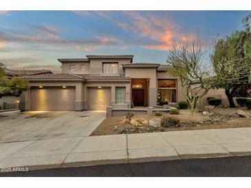 Beautiful two-story home with a three-car garage and desert landscaping at 11036 E Evans Rd, Scottsdale, AZ 85255