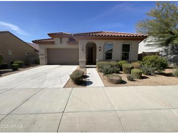 Charming single-story home featuring a desert landscape, a terracotta roof, and a two-car garage at 12164 S 184Th Ave, Goodyear, AZ 85338