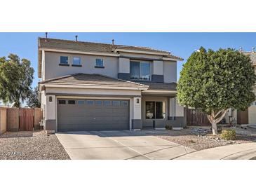 Charming two-story home with a well-maintained front yard and a two car garage, perfect for a growing Gathering at 14532 N 146Th Ln, Surprise, AZ 85379