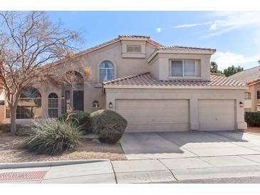 Charming two-story home featuring a three-car garage, desert landscaping, and a tile roof at 1901 W Mulberry Dr, Chandler, AZ 85286