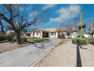 Charming single-story home with a winding driveway and desert landscaping at 8310 W Daley Ln, Peoria, AZ 85383