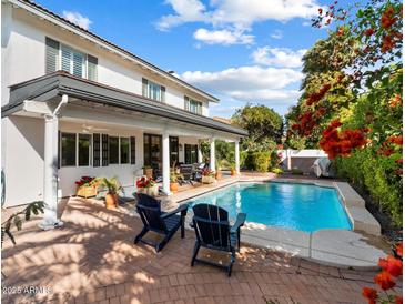 A lovely backyard with a pool, greenery, and inviting outdoor seating at 8607 N Farview Dr, Scottsdale, AZ 85258