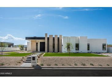 Modern home boasting a geometric design, manicured lawn, and desert landscaping at 10220 N 66Th St, Paradise Valley, AZ 85253