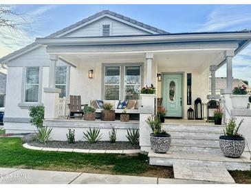 Inviting front porch with a light blue door, bench seating, and stone steps at 2643 E Tamarisk St, Gilbert, AZ 85296