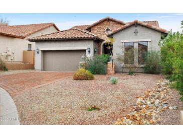 Charming home featuring stone accents, desert landscaping, and a brick-paved driveway at 6959 E Red Hawk Cir, Mesa, AZ 85207