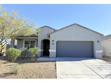 Charming single-story home featuring desert landscaping, gray exterior, and a two-car garage at 1075 W Avalon Canyon Dr, Casa Grande, AZ 85122