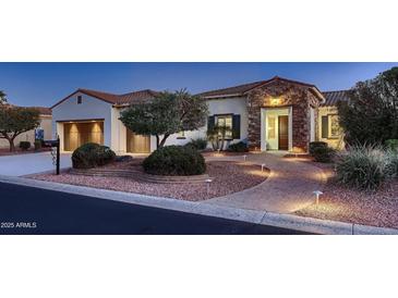 Charming single-story home featuring a stone facade, terracotta roof, and inviting walkway, enhancing curb appeal at 13117 W Micheltorena Dr, Sun City West, AZ 85375