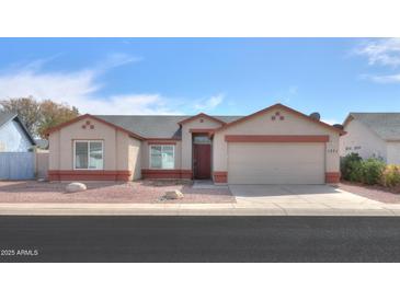 Charming single-story home with desert landscaping and a two-car garage at 1371 E Cactus Bloom Way, Casa Grande, AZ 85122