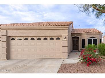 Charming single-story home with neutral stucco, tile roof, and desert landscaping at 2101 S Yellow Wood -- # 22, Mesa, AZ 85209