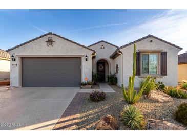 Charming single-story home showcasing a stucco exterior, desert landscaping, and a gray two-car garage at 26509 W Ponderosa Ln, Buckeye, AZ 85396