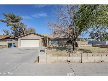 Charming single-story home with a tidy front yard, brick accents, and an attached two-car garage at 2728 W Redfield Rd, Phoenix, AZ 85053