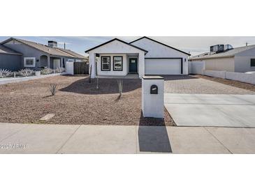 Charming home featuring a well-maintained front yard and a stylish black and white exterior at 2749 E Wier Ave, Phoenix, AZ 85040