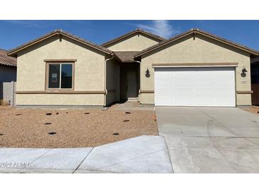 Charming single-story home with desert landscaping, attached garage, and covered front entryway at 31512 N Hayweather Ln, San Tan Valley, AZ 85143