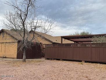 Cozy single-Gathering home featuring a fenced yard and covered patio for outdoor enjoyment at 3814 E Acoma Dr, Phoenix, AZ 85032