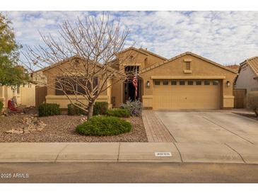 Charming single-story home with a well-maintained front yard, a two car garage, and desert landscaping at 3896 E Aragonite Ln, San Tan Valley, AZ 85143