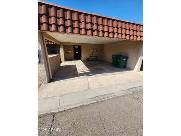 Covered carport with a red tile roof provides shelter for vehicles and direct access to the property at 5228 N 15Th Dr, Phoenix, AZ 85015