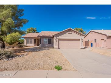 Charming single-story home with a well-maintained front yard and two-car garage at 6450 S Windstream Pl, Chandler, AZ 85249