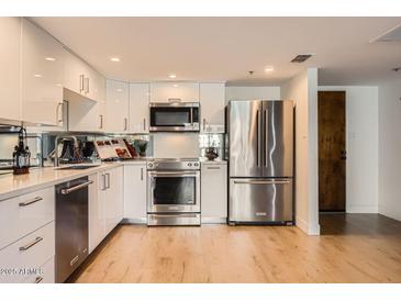 Modern kitchen featuring stainless steel appliances and white cabinetry at 7950 E Camelback Rd # 310, Scottsdale, AZ 85251