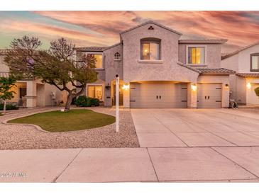 Charming two-story home with a well-manicured front yard and spacious three-car garage at 11718 N 152Nd Dr, Surprise, AZ 85379