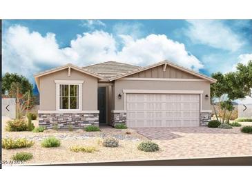Beautiful one-story home featuring a neutral color scheme, rock detail, desert landscaping, and a spacious two-car garage at 21465 N Rummler Ln, Maricopa, AZ 85138