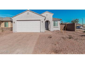 Charming single-story home with desert landscaping, a two-car garage, and a welcoming front entrance at 6722 W Desert Dr, Laveen, AZ 85339