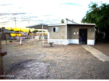 Exterior of a single story home, with desert landscaping at 9716 E Birchwood Ave, Mesa, AZ 85208
