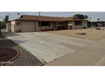 Charming single-story home with low-maintenance desert landscaping and spacious driveway at 12236 N Pebble Beach Dr, Sun City, AZ 85351