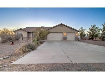 Charming single-story home with a spacious driveway and a two-car garage at 12326 N Lang Rd, Florence, AZ 85132