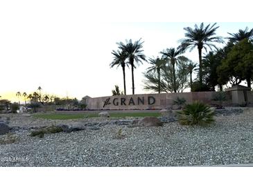 Stone community sign surrounded by desert landscaping and palm trees against a bright sky at 15712 W Eucalyptus Ct, Surprise, AZ 85374